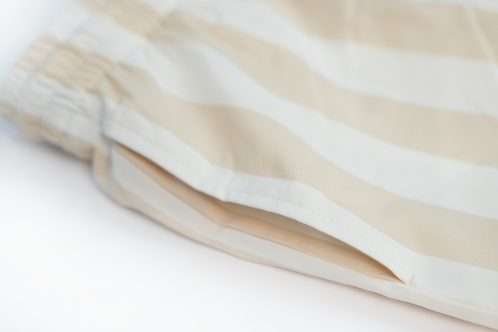 beige striped swim shorts